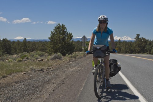 Carly on route with the beautiful mountains surrounding Bend in the background